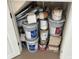 Close-up view of paint cans and supplies neatly stored in a closet at 7762 Linkside Loop, Reunion, FL 34747