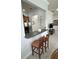 Kitchen counter with two bar stools, view into kitchen and living room at 7762 Linkside Loop, Reunion, FL 34747