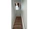 Elegant carpeted staircase with a classic design at 7762 Linkside Loop, Reunion, FL 34747