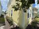 Side view of yellow house with white trim and landscaping at 7762 Linkside Loop, Reunion, FL 34747