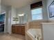 Elegant bathroom with double vanity, soaking tub, and separate shower at 7762 Linkside Loop, Reunion, FL 34747