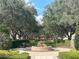 Walkway lined with trees leading to a fountain at 7762 Linkside Loop, Reunion, FL 34747