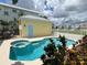 Inviting pool and spa area with a yellow shed in the background at 7762 Linkside Loop, Reunion, FL 34747