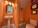 Small powder room with pedestal sink and toilet at 7762 Linkside Loop, Reunion, FL 34747