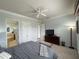 King-size bed in main bedroom with access to bathroom at 7762 Linkside Loop, Reunion, FL 34747