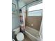 Bathroom with shower/tub combo and tile surround at 7762 Linkside Loop, Reunion, FL 34747