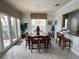 Bright dining room with a large table, six chairs and view into kitchen at 7762 Linkside Loop, Reunion, FL 34747