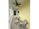Relaxing porch with two chairs and a small table, overlooking neighboring houses at 7762 Linkside Loop, Reunion, FL 34747