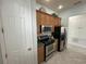 Clean kitchen with stainless steel appliances and wood cabinets at 7762 Linkside Loop, Reunion, FL 34747