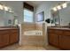 Bathroom with corner bathtub and double vanity at 7762 Linkside Loop, Reunion, FL 34747