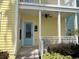Front porch with light blue door and white railings at 7762 Linkside Loop, Reunion, FL 34747