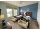 Two twin beds, ceiling fan, and lake view from window in this bright bedroom at 7762 Linkside Loop, Reunion, FL 34747