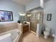 Bathroom with a shower, bathtub, and double vanity at 7762 Linkside Loop, Reunion, FL 34747