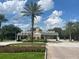 Gated community entrance with palm trees and landscaping at 7762 Linkside Loop, Reunion, FL 34747
