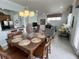 Spacious dining area with large table, six chairs, kitchen and living room views at 7762 Linkside Loop, Reunion, FL 34747
