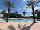 Large, inviting community pool surrounded by palm trees at 7762 Linkside Loop, Reunion, FL 34747