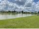 Serene lake view with a fountain and lush green grass at 7762 Linkside Loop, Reunion, FL 34747