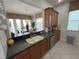 Open kitchen with breakfast bar overlooking dining area and pool at 7762 Linkside Loop, Reunion, FL 34747