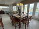 Bright dining area with a large table, six chairs, and pool access at 7762 Linkside Loop, Reunion, FL 34747