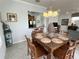 Bright dining area with a large table and six chairs, kitchen access at 7762 Linkside Loop, Reunion, FL 34747
