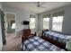 Two twin beds, ceiling fan, and access to a hallway in this bedroom at 7762 Linkside Loop, Reunion, FL 34747