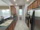 Modern kitchen featuring stainless steel appliances and double sink at 7762 Linkside Loop, Reunion, FL 34747