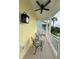 Relaxing porch with two chairs and a small table, overlooking the neighborhood at 7762 Linkside Loop, Reunion, FL 34747