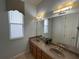 Double vanity bathroom with updated light fixtures at 7762 Linkside Loop, Reunion, FL 34747