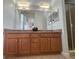 Double vanity bathroom with large mirror and shower at 7762 Linkside Loop, Reunion, FL 34747