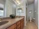 Double vanity bathroom with a large mirror and shower at 7762 Linkside Loop, Reunion, FL 34747