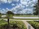 Picturesque view of a lake with houses in the background at 7762 Linkside Loop, Reunion, FL 34747