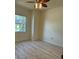 Bright bedroom with ceiling fan and wood-look flooring at 2470 Salzburg Loop, Winter Haven, FL 33884