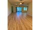 Open living room with hardwood floors and ceiling fans at 2470 Salzburg Loop, Winter Haven, FL 33884
