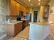 Bright kitchen with wood cabinets, stainless steel appliances, and tile flooring at 2470 Salzburg Loop, Winter Haven, FL 33884