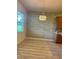 Dining area with hardwood floors and a stylish light fixture at 2470 Salzburg Loop, Winter Haven, FL 33884
