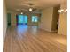 Open concept living room with hardwood floors and lots of natural light at 2470 Salzburg Loop, Winter Haven, FL 33884