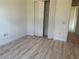 Bedroom with double-door closet and wood-look flooring at 2470 Salzburg Loop, Winter Haven, FL 33884
