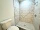 Updated bathroom with a large shower and marble tile at 1312 Hillsborough Ct, Poinciana, FL 34759