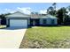 Newly built home with a two-car garage and spacious lawn at 1312 Hillsborough Ct, Poinciana, FL 34759