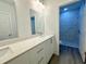 Modern bathroom with double vanity, quartz countertop and shower at 1312 Hillsborough Ct, Poinciana, FL 34759