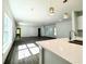 Modern kitchen with island, double sink, and white cabinets at 1312 Hillsborough Ct, Poinciana, FL 34759