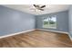 Well-lit bedroom with wood-look flooring and neutral walls at 1025 Dudley Dr, Kissimmee, FL 34758