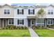 Two-story townhome with gray siding, landscaping, and walkway at 1436 Silver Lining Way, Apopka, FL 32703