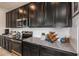 Kitchen with dark cabinetry, stainless steel appliances, and granite countertops at 1455 Alston Bay Blvd, Apopka, FL 32703