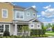 Two-story townhome with light blue and yellow siding at 1455 Alston Bay Blvd, Apopka, FL 32703