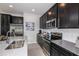 Modern kitchen with stainless steel appliances and dark cabinetry at 1455 Alston Bay Blvd, Apopka, FL 32703