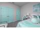 Bedroom with teal and gray color scheme and built-in closet at 1455 Alston Bay Blvd, Apopka, FL 32703