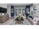 Spacious living room with gray sofas and blue accents at 1455 Alston Bay Blvd, Apopka, FL 32703