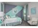 Bedroom with teal and gray color scheme, featuring a comfortable bed and stylish decor at 1455 Alston Bay Blvd, Apopka, FL 32703