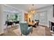 Elegant dining room with a live-edge wood table and blue velvet chairs at 727 Park Lake Cir, Orlando, FL 32803